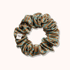 Brown scrunchie with blue patterns on a white background