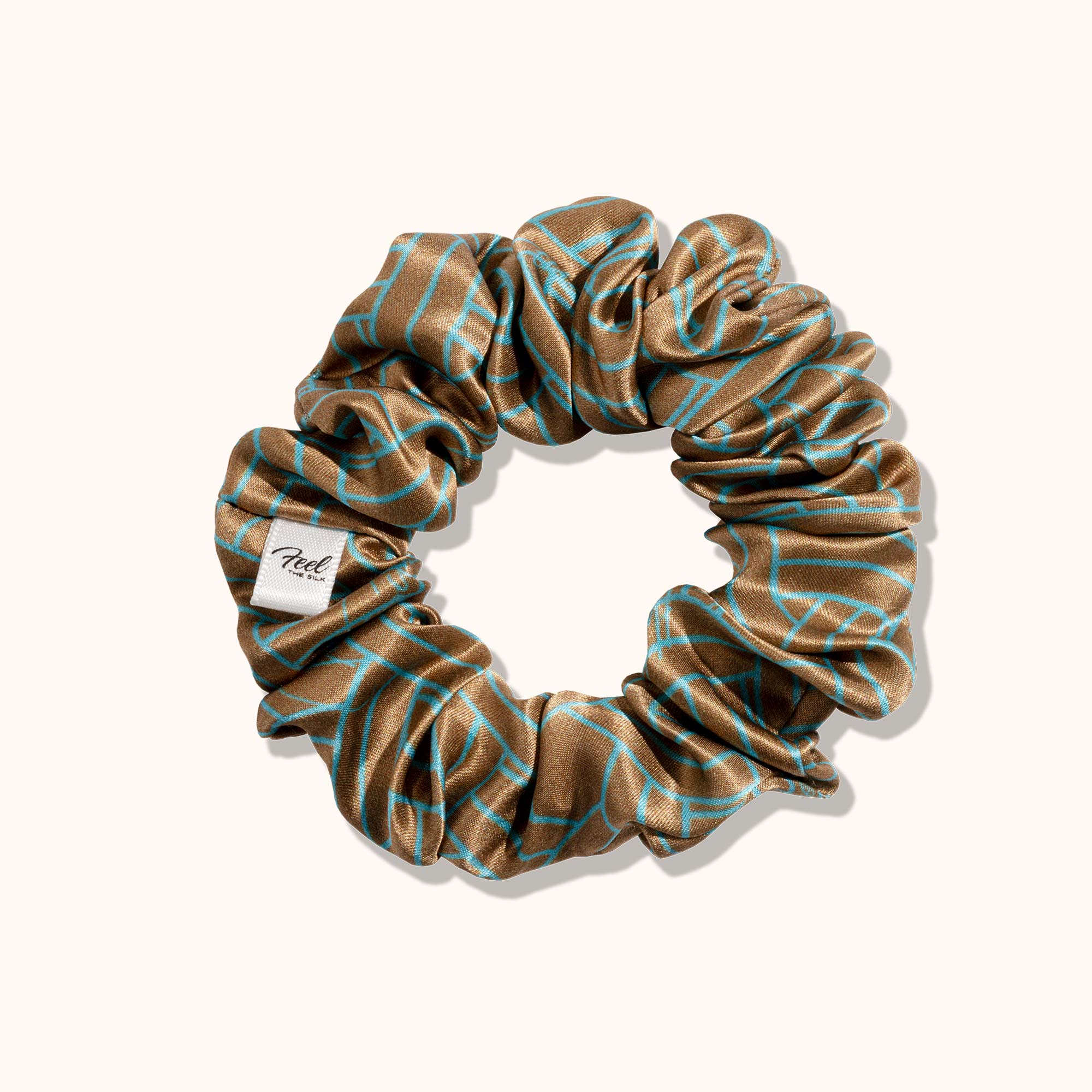 Brown scrunchie with blue patterns on a white background